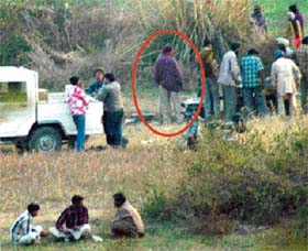Liquor being illegally sold from a mobile vend near the Jayanti Devi temple in Kharar on Sunday. A policeman (encircled) is also seen standing near a makeshift ahata
