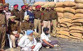 The Jagraon police team with poppy husk smugglers at a naka at Kila Raipur on Sunday