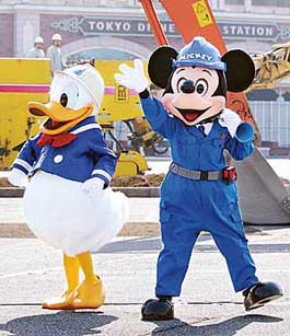 Disney characters Mickey Mouse and Donald Duck clad in hard hats at construction work take part in a ceremony marking construction of a hotel at Tokyo Disneyland on Tuesday.