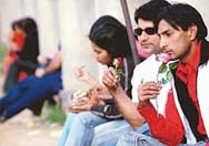Waiting for their Valentine: Students of Panjab University hold flowers in the hope to find somebody to whom they can express their feelings on Valentines Day. 