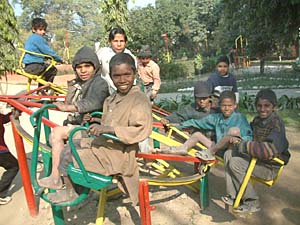 Children working as rag pickers take a day out in the Company Garden in the city.