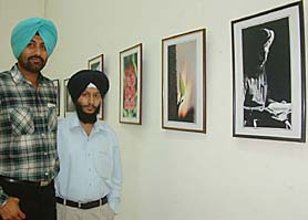 Tejbir Singh (left) and Sandeep Singh at an exhibition of their photographs in the city. 