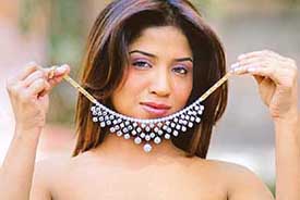 A model displays a diamond necklace, weighing 99.51 carat with 88 diamonds, in Bangalore on Wednesday. The necklace is priced at Rs 3.75 crore.