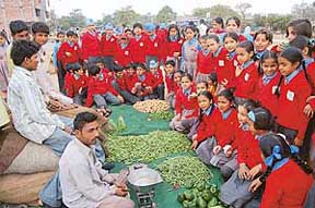 Learning to shop: Students of Class V of Lawrence Public School at the kisan vegetable market in Phase VI, Mohali, on Wednesday. They bought vegetables on good bargains, making a better understanding of the chapter on profit and loss.