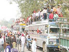 CPM activists board buses to court arrest as part of their jail bharo campaign in Ludhiana on Wednesday.