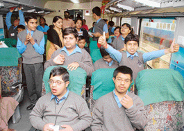 Mentally challanged students enjoy inside the New Delhi-Bhopal Shatabdi Express during the flagging off of the train in New Delhi on Wednesday. 