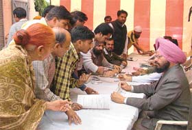 Officials of the District Food and Civil Supplies Department accept applications for ration cards at the Congress office in Ludhiana