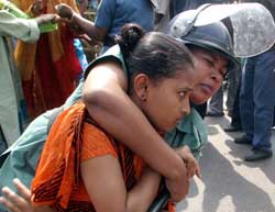 A Bangladeshi policewoman drags a woman activist of the Opposition Awami League during a strike in Dhaka on Wednesday.