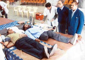 A physically challenged person, Kesar Singh, donates blood at the HMT complex in Pinjore