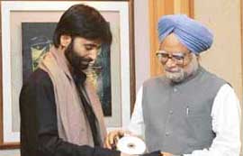 JKLF chairman Yasin Malik presents a pack of CDs to Prime Minister Manmohan Singh prior to a meeting in New Delhi on Friday