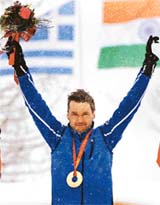 Estonias Andrus Veerpalu celebrates on the podium after winning the mens 15 km cross country race at the Winter Olympic Games in Pragelato, Italy
