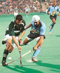 Indias Harpal Singh tries to stop a Pakistani forward during the first encounter of the six-match series at the Sector 42 Hockey Stadium in Chandigarh