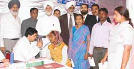 A doctor examines a patient during a free eye check-up and operation camp organised by the Sant Nirankari Mandal in Ludhiana on Sunday. At least 1,600 patients were examined and 145 of them operated upon by a team of doctors led by Dr Ramesh Mansooranwala
