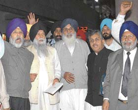 Members of the Opposition led by Mr Parkash Singh Badal raise slogans while walking out from the chamber of the Punjab Vidhan Sabha in Chandigarh on the opening day of the Budget session