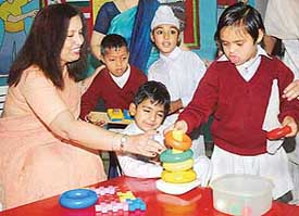 The President of the Western Command chapter of the Army Wives Welfare Association, Ms Mohini Daljeet Singh, interacts with students of Asha School for special children in Chandi Mandir on Wednesday.