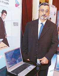 Executive Vice-President, HCL Infosystems, George Paul, poses with a newly launched HCL laptop at a press conference in New Delhi on Thursday. HCL Infosystems entered the laptop market by launching 14 notebooks at prices ranging between $617 and $1,213. 