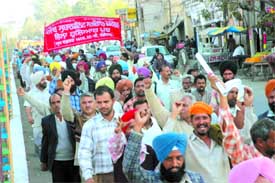Members of the Punjab Subordinate Services Federation hold a protest march against Punjab government, in Jalandhar on Thursday