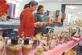 Visitors look at artifacts at an exhibition organised by the Tamil Nadu Handicrafts Development Corporation Limited in Ludhiana on Thursday