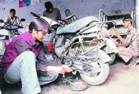Anju, a much-in-demand mechanic, carries out repairs in her workshop.