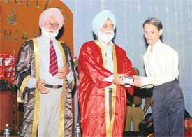 Mr Jasjit Singh Randhawa awards a student during the annual prize distribution function at the SCD Government College in Ludhiana on Saturday