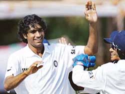 Munaf Patel of Board Presidents XI celebrates with team-mates after taking the wicket of Englands Ian Blackwell on the third and final day of the warm-up match in Vadodara on Saturday. 