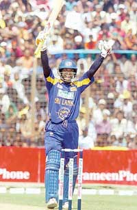 Sri Lankas Kumar Sangakkara raises his bat after scoring a century during the third one-dayer against Bangladesh in Chittagong on Saturday. 