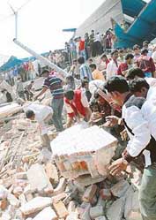 Bangladeshi rescue workers search for victims at the site of a collapsed building in Dhaka on Saturday.