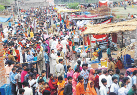 Devotees at Pracheen Shiv Mandir, Mahadevpura, wait for their turn to pay obeisance to Lord Shiva on Shivratri in Panchkula on Sunday. 