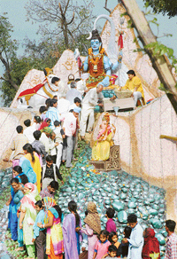 Devotees wait at Shri Kailashpati Temple in Patiala on Sunday.