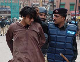 The Pakistan police detains a supporter of the Opposition Islamic Alliance for defying a ban on rallies in Lahore on Sunday