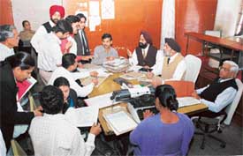 Mr A.S. Narula, president of the Consumer Forum, hears litigants during a lok adalat in Ludhiana on Tuesday