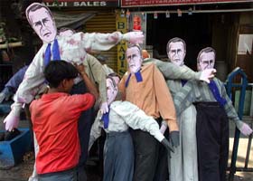 An activist arranges effigies of U S President George W Bush in Kolkata
