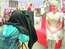 Sadanand Kaur, Principal of Miri Piri Academy, poses for a photograph to be clicked with jhat phat camera, during the exhibition. 