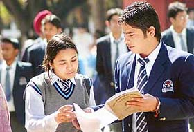 Class XII students discuss the question paper on the first day of the CBSE exams which started today