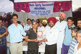 A player gets prize following the final match of a volleyball tournament organised by the Nehru Yuva Kendra Jan Chetna Youth Club at Daria village