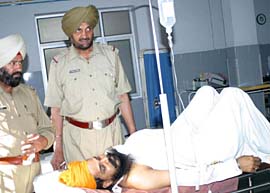Sukhwant Singh, a security guard at the Maqsudan branch of the Centurion Bank of Punjab, who was shot at and injured by robbers, recovers in a hospital in Jalandhar on Wednesday.