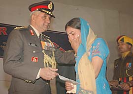 A war widow being given a cheque during the silver jubilee function of the 18th Battalion of the Dogra Regiment in Jalandhar on Wednesday. 