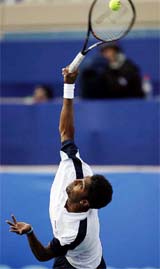 Prakash Amritraj serves to American Mardy Fish during the first round of the Tennis Channel Open tennis tournament in Las Vegas
