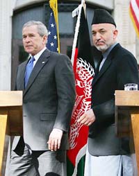 US President George W Bush and Afghan President Hamid Karzai arrive for a news conference at the Presidential Palace in Kabul on Wednesday. 