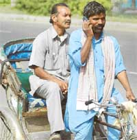A rickshawpuller finalises his next destination as he ferries a passenger