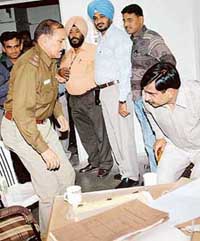 CBI officials arrest Sub-Inspector Pyare Lal during a raid on the Economic Offences Wing of the Chandigarh Police in Sector 17, Chandigarh, on Friday