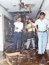 Staff and members of the business arcade of Hotel Shivaliview, Sector 17, Chandigarh, clear up the rubble after a fire broke out there on Friday