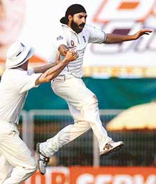 Englands Monty Panesar and Andrew Strauss celebrate the dismissal of Indias Mohammad Kaif on the third day of the first Test in Nagpur on Friday