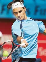 Roger Federer of Switzerland returns a shot to Mikhail Youzhny of Russia during their semifinal at the Dubai Open tournament on Friday