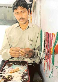 Raju Pyare Puriawala stringing a delicate necklace for a petite neck. 