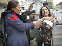 Pakistani police arrest an activist from a non-government organisation during an anti-Bush rally in Rawalpindi on Saturday. 