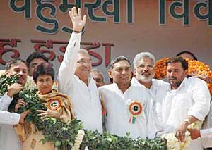 Haryana Chief Minister Bhupinder Singh Hooda (hand raised) at Navnirman rally in Hisar on Sunday.