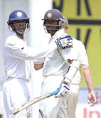 Rahul Dravid congratulates Wasim Jaffer on completing a half century on the fifth day of the first Test against England at the VCA Stadium in Nagpur on Sunday