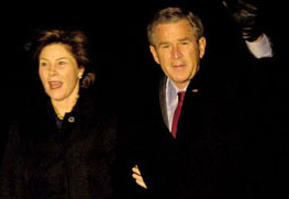 US President George W. Bush waves as he and First Lady Laura Bush walk across the South Lawn upon their return at the White House in Washington on Sunday. Bush was returning from a trip to South Asia, where he visited Afghanistan, India and Pakistan.