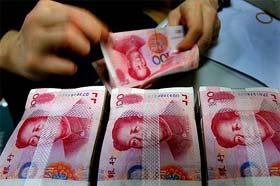 A Chinese bank employee counts yuan notes at a local bank in Nanjing